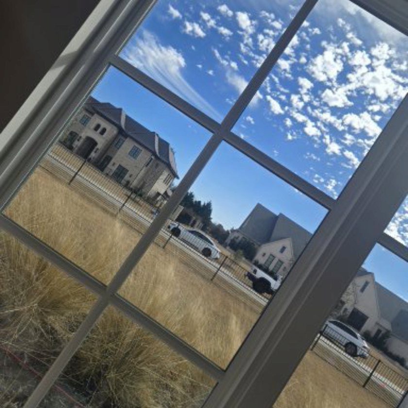 Streak-free clean windows reflecting a bright sky in Frisco, TX